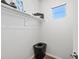 Simple closet featuring a single shelf, clothes, shoes, and a black plastic storage basket at 3453 N Gold Bug Ct, Aurora, CO 80019