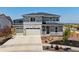 Charming two-story home showcasing a three-car garage and manicured front yard landscaping at 3453 N Gold Bug Ct, Aurora, CO 80019