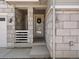 Inviting front porch featuring stone columns and a decorative wreath, adding curb appeal to the home at 3453 N Gold Bug Ct, Aurora, CO 80019