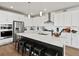 Modern kitchen with white cabinets, stainless steel appliances, and a large island with seating at 3453 N Gold Bug Ct, Aurora, CO 80019