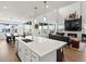 Open concept kitchen with a view into the living room featuring a fireplace, and dining area at 3453 N Gold Bug Ct, Aurora, CO 80019