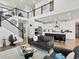Spacious living room features an open floor plan with a modern staircase and adjacent kitchen at 3453 N Gold Bug Ct, Aurora, CO 80019