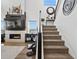 Bright open living space with fireplace, staircase, modern finishes and artistic decor at 3453 N Gold Bug Ct, Aurora, CO 80019