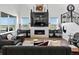 Elegant living room with a fireplace and large windows offering stunning views of the neighborhood at 3453 N Gold Bug Ct, Aurora, CO 80019
