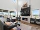 Inviting living room with a floor-to-ceiling fireplace and large windows providing ample natural light at 3453 N Gold Bug Ct, Aurora, CO 80019