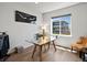 Bright office with a glass desk and natural light from a large window overlooking the neighborhood at 3453 N Gold Bug Ct, Aurora, CO 80019