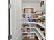Walk-in pantry with organized shelving stocked with various food items and household supplies at 3453 N Gold Bug Ct, Aurora, CO 80019