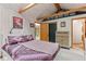 Charming bedroom with closet space, a window with forest views, and wooden beams at 30264 Upper Bear Creek Rd, Evergreen, CO 80439