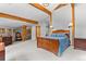 Large bedroom features exposed beams, and multiple access points to other rooms at 30264 Upper Bear Creek Rd, Evergreen, CO 80439