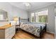 Comfortable bedroom with hardwood floors, an iron bed frame, and a window showcasing tree views at 30264 Upper Bear Creek Rd, Evergreen, CO 80439
