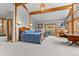 Spacious bedroom features exposed beams, natural light, and access to an en-suite bathroom at 30264 Upper Bear Creek Rd, Evergreen, CO 80439