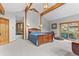 Cozy bedroom with exposed beams and a sliding door to the backyard at 30264 Upper Bear Creek Rd, Evergreen, CO 80439