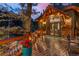 Inviting deck space with exposed beams, outdoor lighting and wood railings at 30264 Upper Bear Creek Rd, Evergreen, CO 80439