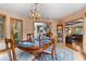 Bright dining room with wood accents, antler chandelier, and views into the kitchen and living area at 30264 Upper Bear Creek Rd, Evergreen, CO 80439