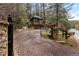 Gated driveway and entrance to home, with stone pillars and mailbox visible at 30264 Upper Bear Creek Rd, Evergreen, CO 80439