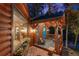 Cabin porch with flower boxes, blue door, and chairs, offering a cozy and inviting outdoor space at 30264 Upper Bear Creek Rd, Evergreen, CO 80439