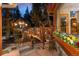 Cozy cabin exterior featuring a beautifully decorated wooden deck and vibrant flower boxes at 30264 Upper Bear Creek Rd, Evergreen, CO 80439