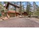 View of garage with car space under the house with a large gravel driveway at 30264 Upper Bear Creek Rd, Evergreen, CO 80439