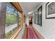 Hallway with large view windows, skylight, and terracotta tile flooring leading into interior at 30264 Upper Bear Creek Rd, Evergreen, CO 80439
