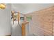 Hallway with log walls and a view of the lush greenery outside at 30264 Upper Bear Creek Rd, Evergreen, CO 80439