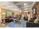 Bright living room with exposed beam ceilings, stone fireplace, and comfortable seating arrangement at 30264 Upper Bear Creek Rd, Evergreen, CO 80439