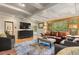 Bright living room with exposed beam ceilings, large windows, and comfortable furnishings at 30264 Upper Bear Creek Rd, Evergreen, CO 80439
