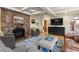 Living room with a stone fireplace, hardwood floors, and comfortable seating at 30264 Upper Bear Creek Rd, Evergreen, CO 80439