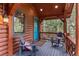 Inviting porch with cozy seating, rustic wood accents, and serene forest views for relaxed outdoor living at 30264 Upper Bear Creek Rd, Evergreen, CO 80439