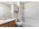Clean bathroom featuring vanity with sink, white tiles, and shower at 5168 Goshawk St, Brighton, CO 80601