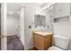 Well-lit bathroom with vanity, mirror, and storage at 5168 Goshawk St, Brighton, CO 80601