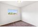 This bedroom features a window that provides natural light, carpet and neutral paint at 5168 Goshawk St, Brighton, CO 80601