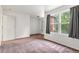 Cozy bedroom with neutral carpet, large windows, and ample natural light at 5168 Goshawk St, Brighton, CO 80601