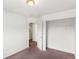 Bright bedroom features neutral walls, carpet, and a closet for ample storage at 5168 Goshawk St, Brighton, CO 80601