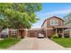 Suburban home showcasing inviting curb appeal with a long driveway and green lawns at 5168 Goshawk St, Brighton, CO 80601