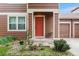 Inviting front door with small porch, colorful garden and meticulous landscaping at 5168 Goshawk St, Brighton, CO 80601