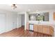 Well-lit kitchen with wood floors, stainless dishwasher and ample storage space at 5168 Goshawk St, Brighton, CO 80601