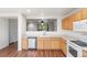 Functional kitchen featuring white countertops, modern appliances, and wood flooring at 5168 Goshawk St, Brighton, CO 80601