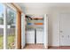 Convenient laundry area with modern washer and dryer, plus storage shelving at 5168 Goshawk St, Brighton, CO 80601