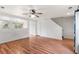 Spacious living room with wood floors, open floor plan, and kitchen view at 5168 Goshawk St, Brighton, CO 80601