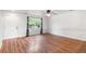 Bright living room featuring wood floors, white walls, and a large window at 5168 Goshawk St, Brighton, CO 80601