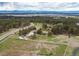 Expansive aerial view of a home with white fencing, lush greenery, and mountain views at 10393 Deerfield Rd, Franktown, CO 80116