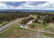 Expansive aerial view of a home with white fencing, lush greenery, and mountain views at 10393 Deerfield Rd, Franktown, CO 80116