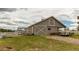 Exterior shot of the barn, featuring a large sliding door, adjacent pen and a rustic aesthetic at 10393 Deerfield Rd, Franktown, CO 80116
