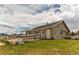 Gray barn with white fence and basketball court at 10393 Deerfield Rd, Franktown, CO 80116