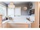 A bathroom with a drop-in tub with white subway tile surround, a chandelier, and decorative accents at 10393 Deerfield Rd, Franktown, CO 80116