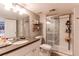 Well-lit bathroom features a glass-enclosed shower, a large vanity with storage, and modern fixtures at 10393 Deerfield Rd, Franktown, CO 80116