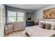 Bright bedroom featuring a large window, a comfortable bed, and neutral decor at 10393 Deerfield Rd, Franktown, CO 80116