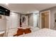Bright bedroom boasts a decorative cowhide rug, neutral walls, and multiple closets for ample storage space at 10393 Deerfield Rd, Franktown, CO 80116