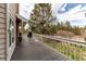 Outdoor deck with painted railings overlooking yard with plenty of trees at 10393 Deerfield Rd, Franktown, CO 80116