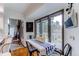 Cozy dining area with views of the deck, featuring a farmhouse-style table and seating for four at 10393 Deerfield Rd, Franktown, CO 80116